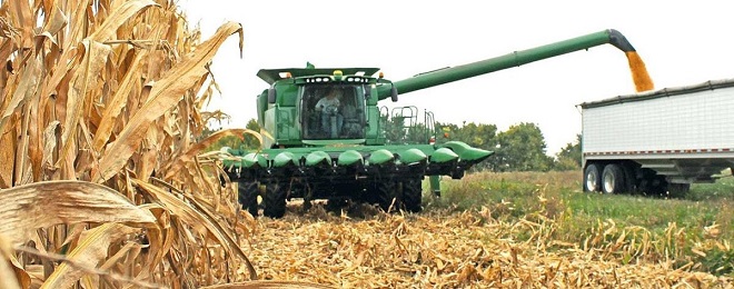 Combine unloading corn in truck